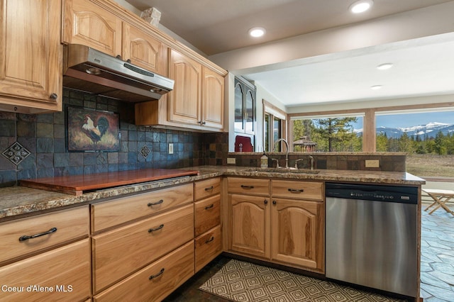 762 Reeder Bay Rd, Nordman, ID 83848 - kitchen featuring stainless steel dishwasher, a sink, under cabinet range hood, decorative backsplash, and dark stone counters