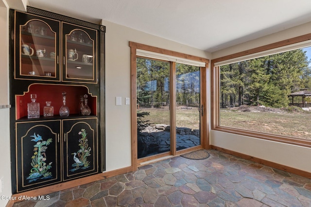 762 Reeder Bay Rd, Nordman, ID 83848 - doorway featuring baseboards and dark stone finish flooring