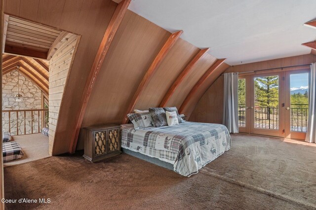 762 Reeder Bay Rd, Nordman, ID 83848 - bedroom with access to exterior, carpet flooring, lofted ceiling, wooden walls, and french doors