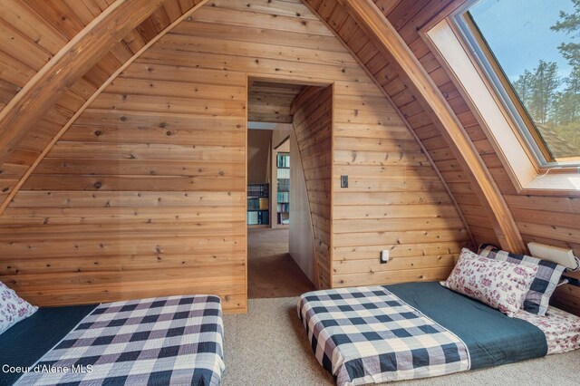 762 Reeder Bay Rd, Nordman, ID 83848 - carpeted bedroom with wooden walls and a skylight