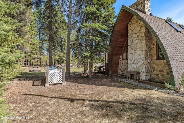 762 Reeder Bay Rd, Nordman, ID 83848 - view of side of home with stone siding and a chimney