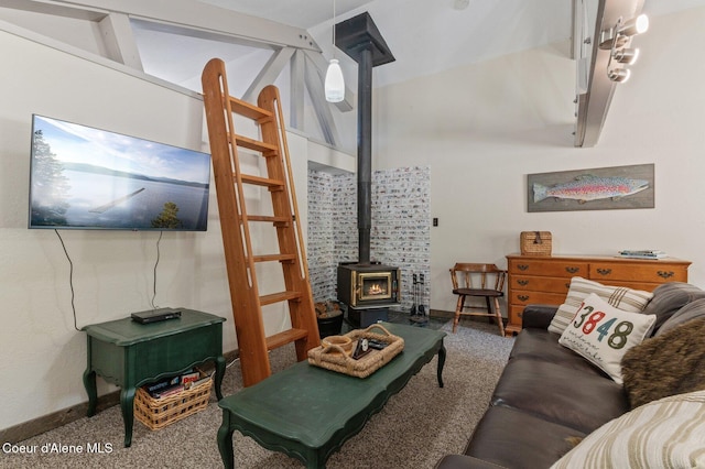 762 Reeder Bay Rd, Nordman, ID 83848 - carpeted living area with a wood stove, baseboards, and lofted ceiling