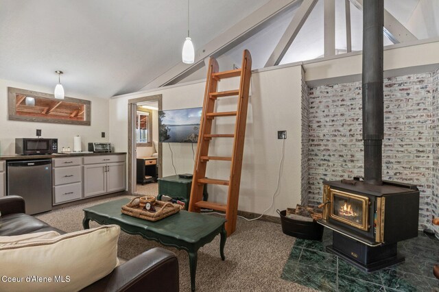 762 Reeder Bay Rd, Nordman, ID 83848 - living area with vaulted ceiling, light colored carpet, and a wood stove