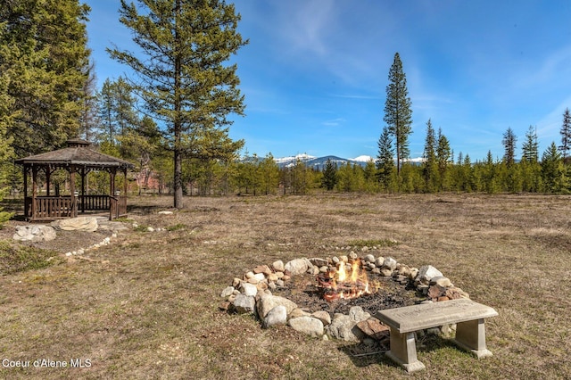 762 Reeder Bay Rd, Nordman, ID 83848 - view of yard with an outdoor fire pit, a gazebo, and a mountain view