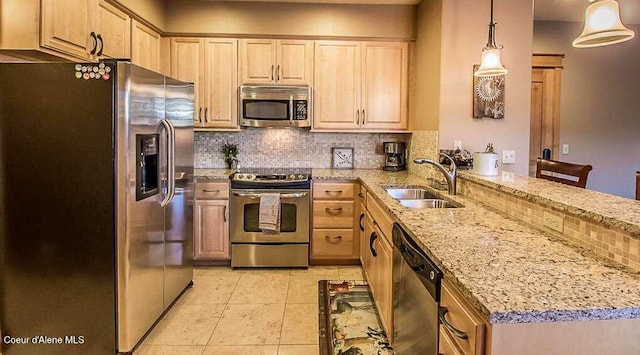 2051 N Main St # 217, Coeur Dalene, ID 83814 - kitchen with stainless steel appliances, a sink, a peninsula, tasteful backsplash, and light brown cabinets