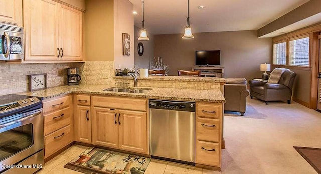 2051 N Main St # 217, Coeur Dalene, ID 83814 - kitchen featuring appliances with stainless steel finishes, a sink, light brown cabinetry, and open floor plan