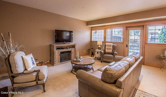 2051 N Main St # 217, Coeur Dalene, ID 83814 - living area featuring light carpet and a glass covered fireplace