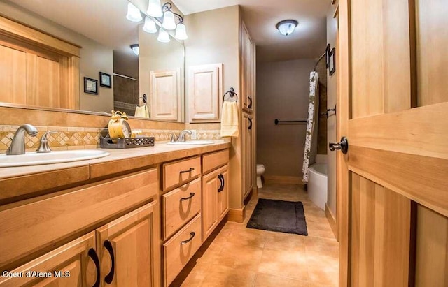 2051 N Main St # 217, Coeur Dalene, ID 83814 - bathroom featuring backsplash, toilet, tile patterned flooring, and double vanity