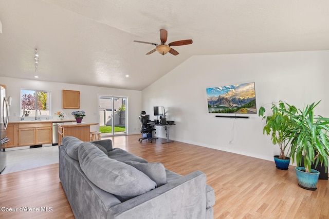 4905 W Lemonwood Ln, Post Falls, ID 83854 - living area with vaulted ceiling, ceiling fan, and light wood finished floors
