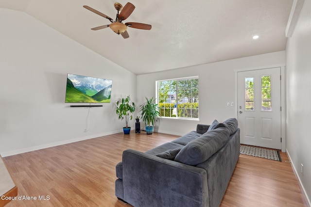 4905 W Lemonwood Ln, Post Falls, ID 83854 - living room featuring vaulted ceiling, light wood-style flooring, plenty of natural light, ceiling fan, and baseboards
