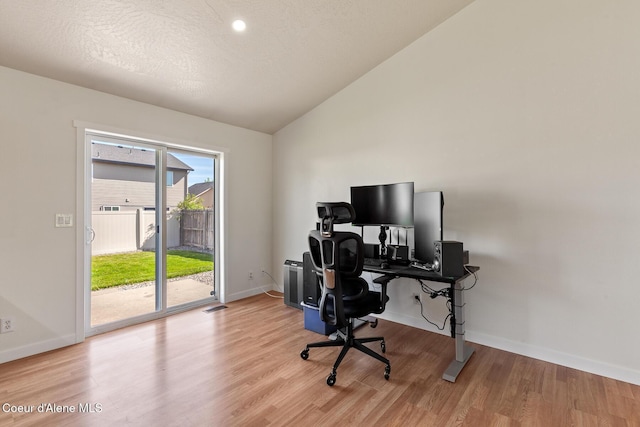 4905 W Lemonwood Ln, Post Falls, ID 83854 - office with lofted ceiling, light wood-style floors, and baseboards