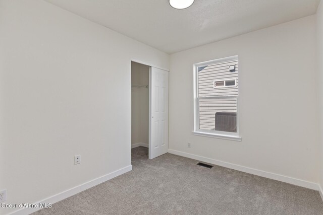 4905 W Lemonwood Ln, Post Falls, ID 83854 - unfurnished bedroom with carpet flooring, baseboards, and a closet