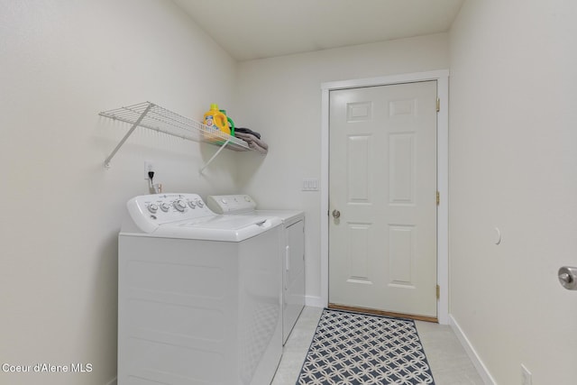 4905 W Lemonwood Ln, Post Falls, ID 83854 - washroom with washer and clothes dryer, baseboards, and light tile patterned floors