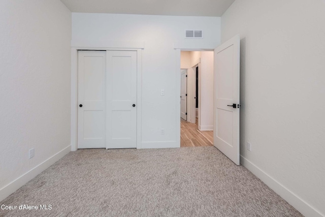 215 White Cloud Dr, Sandpoint, ID 83864 - unfurnished bedroom featuring light carpet, baseboards, and a closet