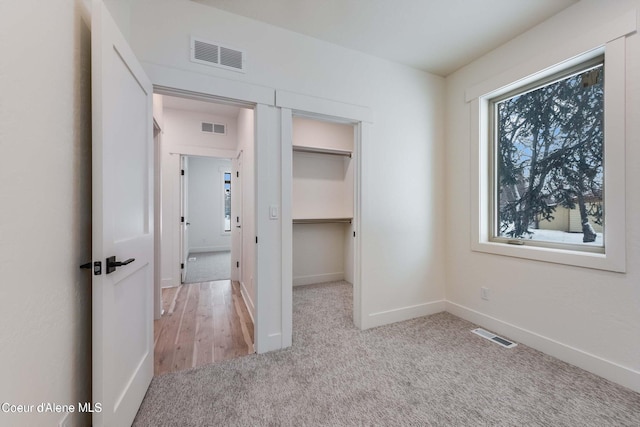 215 White Cloud Dr, Sandpoint, ID 83864 - unfurnished bedroom with carpet floors, baseboards, a walk in closet, and a closet