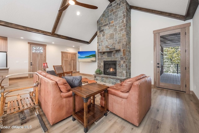215 White Cloud Dr, Sandpoint, ID 83864 - living area featuring beam ceiling, a fireplace, light wood-style floors, healthy amount of natural light, and high vaulted ceiling