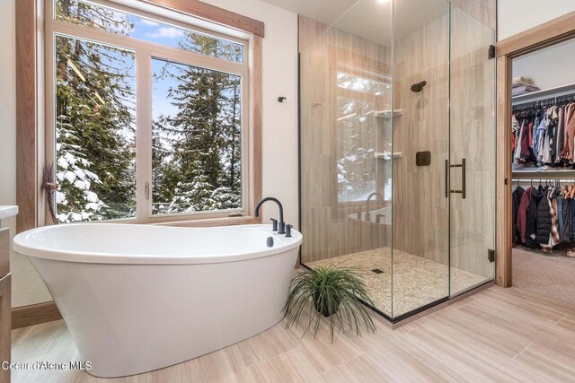 215 White Cloud Dr, Sandpoint, ID 83864 - bathroom with a shower stall, a walk in closet, and a soaking tub