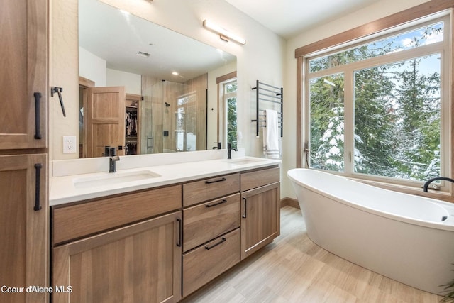 215 White Cloud Dr, Sandpoint, ID 83864 - bathroom with a shower stall, a freestanding bath, double vanity, and a towel warmer