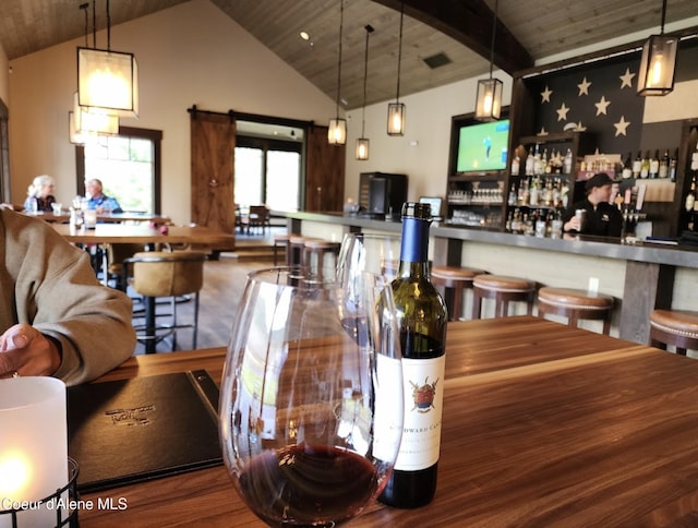 215 White Cloud Dr, Sandpoint, ID 83864 - dining area featuring wooden ceiling, wood finished floors, and a bar