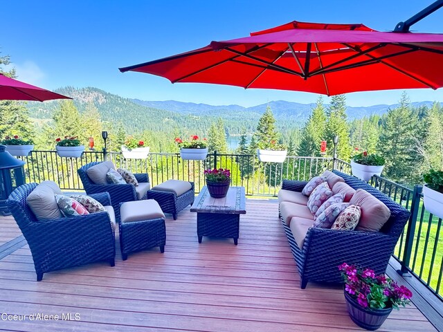 15818 N Morgan Ln, Hayden, ID 83835 - deck featuring an outdoor hangout area, a mountain view, and a wooded view