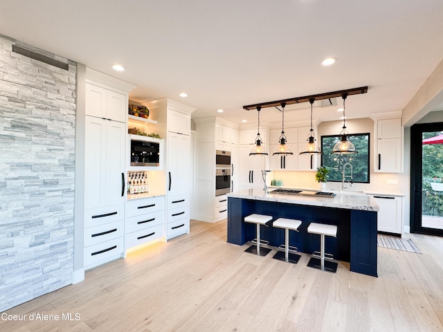 15818 N Morgan Ln, Hayden, ID 83835 - kitchen with white cabinets, light wood finished floors, and recessed lighting