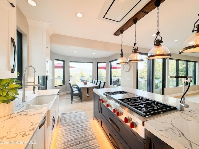 15818 N Morgan Ln, Hayden, ID 83835 - kitchen with stainless steel gas stovetop, plenty of natural light, white cabinets, a sink, and recessed lighting