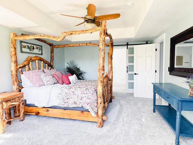 15818 N Morgan Ln, Hayden, ID 83835 - bedroom with carpet flooring, a barn door, and ceiling fan