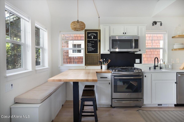 232 Pomrankey Ln, Dover, ID 83825 - kitchen featuring stainless steel appliances, a sink, light wood-type flooring, white cabinetry, and open shelves
