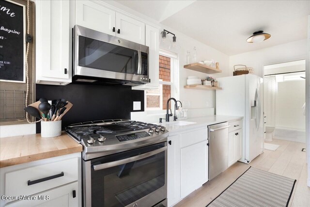 232 Pomrankey Ln, Dover, ID 83825 - kitchen with stainless steel appliances, a sink, plenty of natural light, and white cabinets
