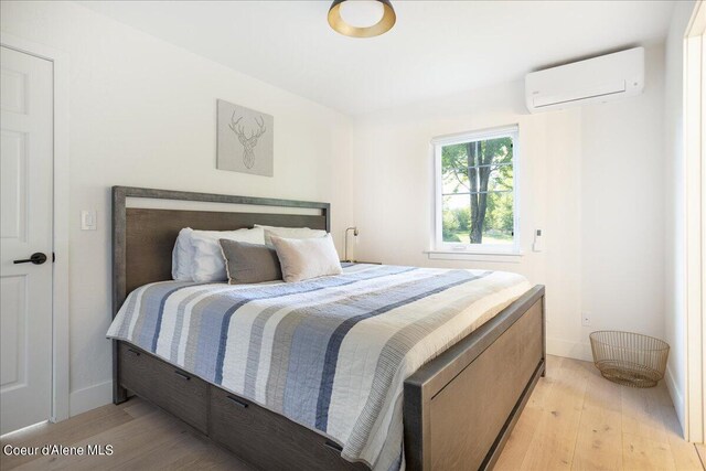 232 Pomrankey Ln, Dover, ID 83825 - bedroom featuring a wall mounted AC, light wood finished floors, and baseboards
