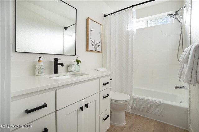 232 Pomrankey Ln, Dover, ID 83825 - full bathroom featuring toilet, vanity, shower / bathtub combination with curtain, and wood finished floors