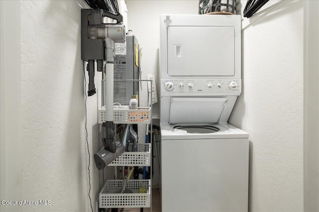 232 Pomrankey Ln, Dover, ID 83825 - clothes washing area featuring stacked washing machine and dryer and a textured wall