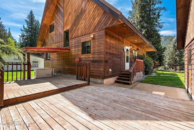wooden deck featuring a lawn
