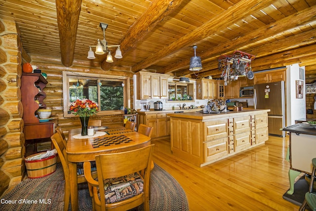 847 Willford Rd, Cocolalla, ID 83813 - kitchen with stainless steel appliances, light wood-style floors, wooden ceiling, rustic walls, and a kitchen island