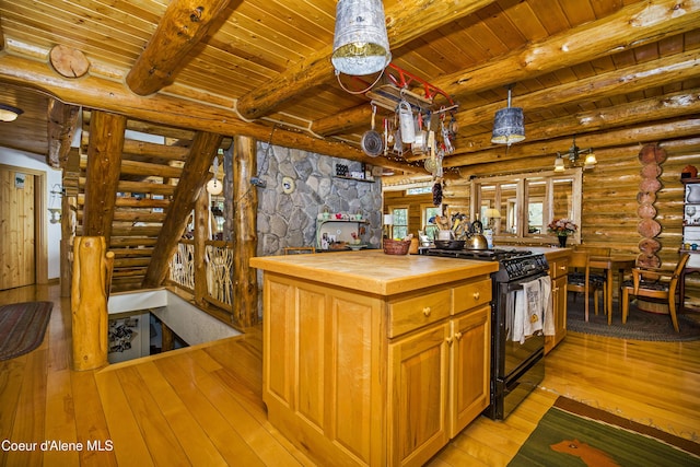 847 Willford Rd, Cocolalla, ID 83813 - kitchen featuring butcher block countertops, black range with gas stovetop, wooden ceiling, log walls, and light wood-style flooring