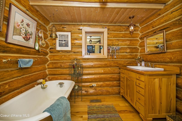 847 Willford Rd, Cocolalla, ID 83813 - bathroom featuring wood ceiling, hardwood / wood-style flooring, a freestanding tub, vanity, and log walls