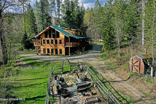 847 Willford Rd, Cocolalla, ID 83813 - back of property with a shed, an outdoor structure, a view of trees, metal roof, and fence