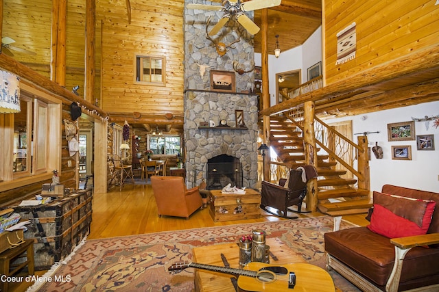 847 Willford Rd, Cocolalla, ID 83813 - living room with a towering ceiling, hardwood / wood-style floors, ceiling fan, stairway, and a fireplace