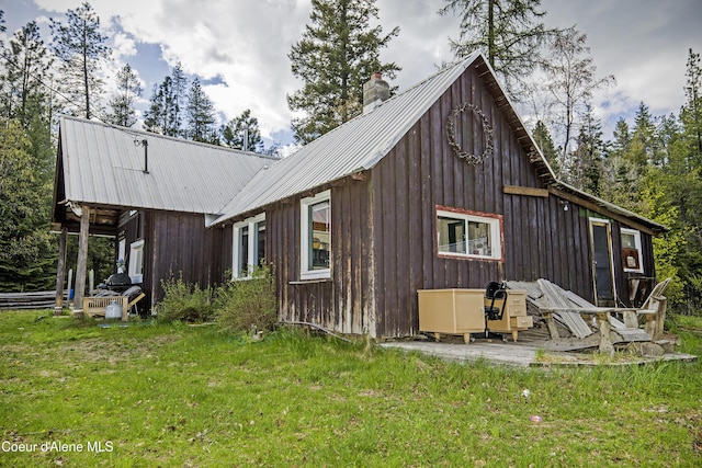 847 Willford Rd, Cocolalla, ID 83813 - view of side of home with metal roof, a yard, and a chimney