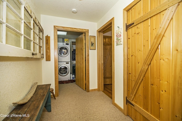 847 Willford Rd, Cocolalla, ID 83813 - hallway featuring estacked washer and dryer, light carpet, and baseboards