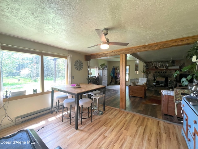 847 Willford Rd, Cocolalla, ID 83813 - dining area with baseboard heating, light wood-style flooring, a textured ceiling, and ceiling fan