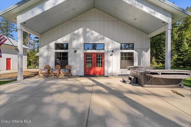 view of outdoor structure with french doors and a hot tub