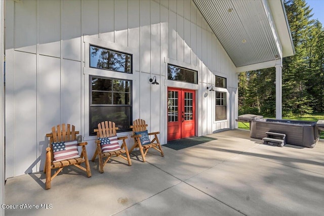 view of patio with a hot tub and french doors