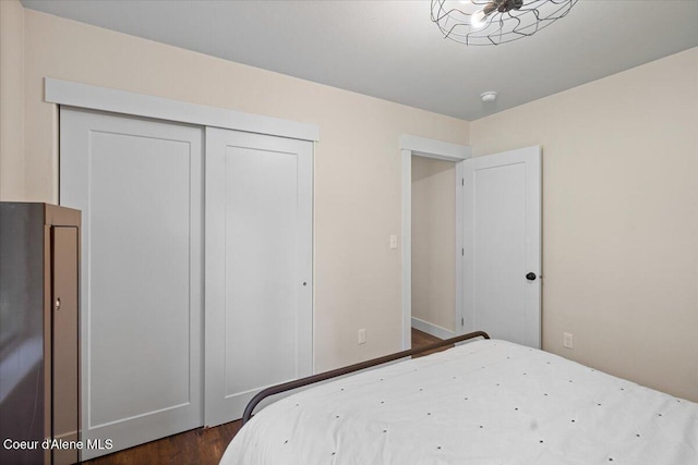 bedroom with a closet and dark wood-type flooring