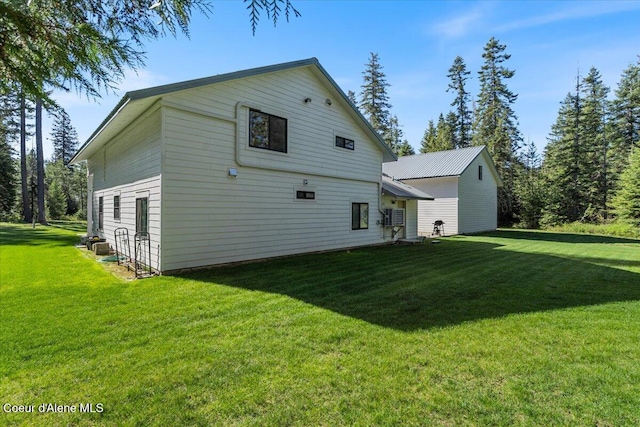 rear view of house featuring a lawn