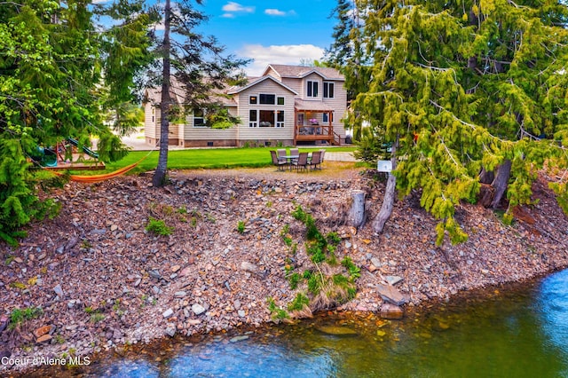 back of property featuring crawl space and a water view