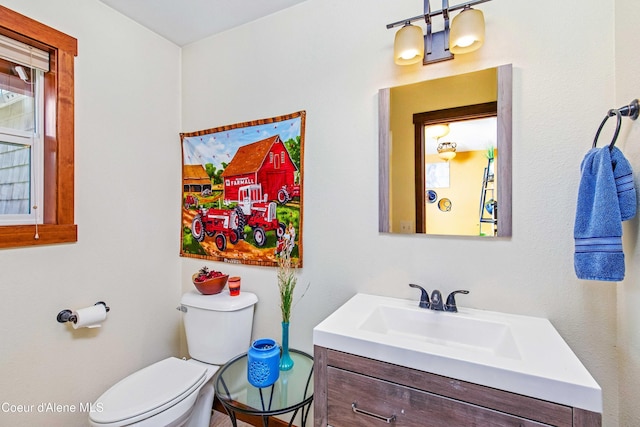 half bathroom featuring toilet and vanity