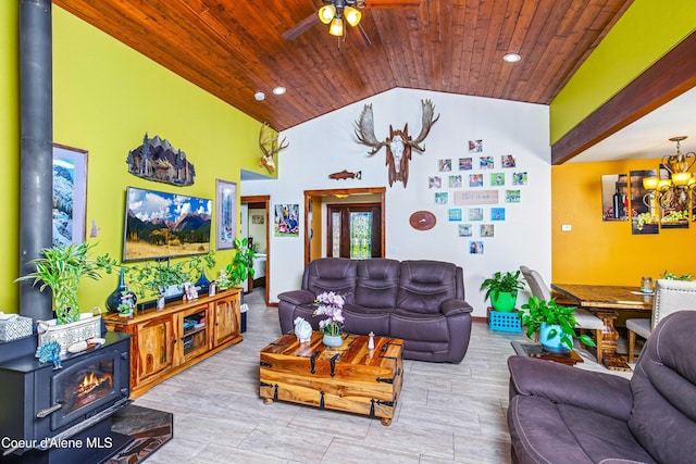 living room with a wood stove, wooden ceiling, ceiling fan, recessed lighting, and a chandelier