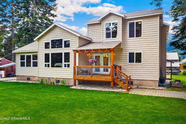 rear view of property with a lawn, roof with shingles, and crawl space