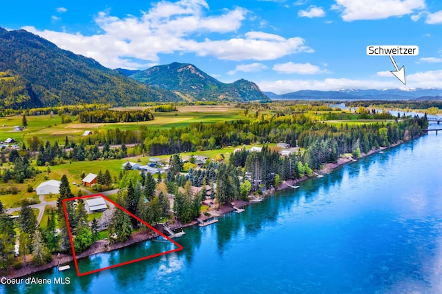 aerial view of property and surrounding area featuring a water and mountain view and property parcel outlined